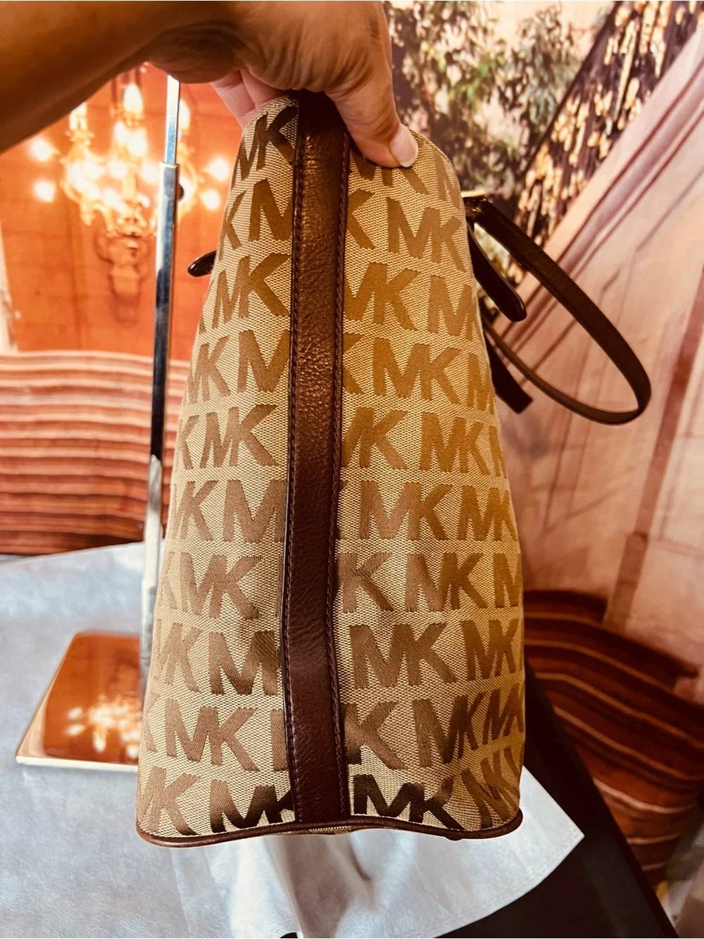Michael Kors Jet Set tote features monogram canvas, contrasting leather straps